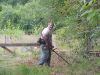 David clearing the building site with a weed-eater. 