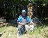 Charlie taking a five gallon bucket form off of a home-made pier block. 