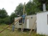 Screwing supports onto the twenty-four foot 6X6 post to make sure it doesn't fall over. 