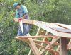 Charlie cuts the ridge pole to length. 
