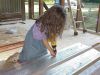 Elizabeth helping get ready to bend a piece of roofing. 