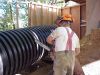 David cutting holes in the well casing to allow water to seep in. 