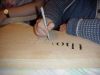 Peggy coloring in engraved words with a brown marker. 