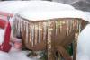 Icicles hanging from an old wheel barrow. 
