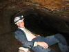The professional caver relaxing in his underground office. 